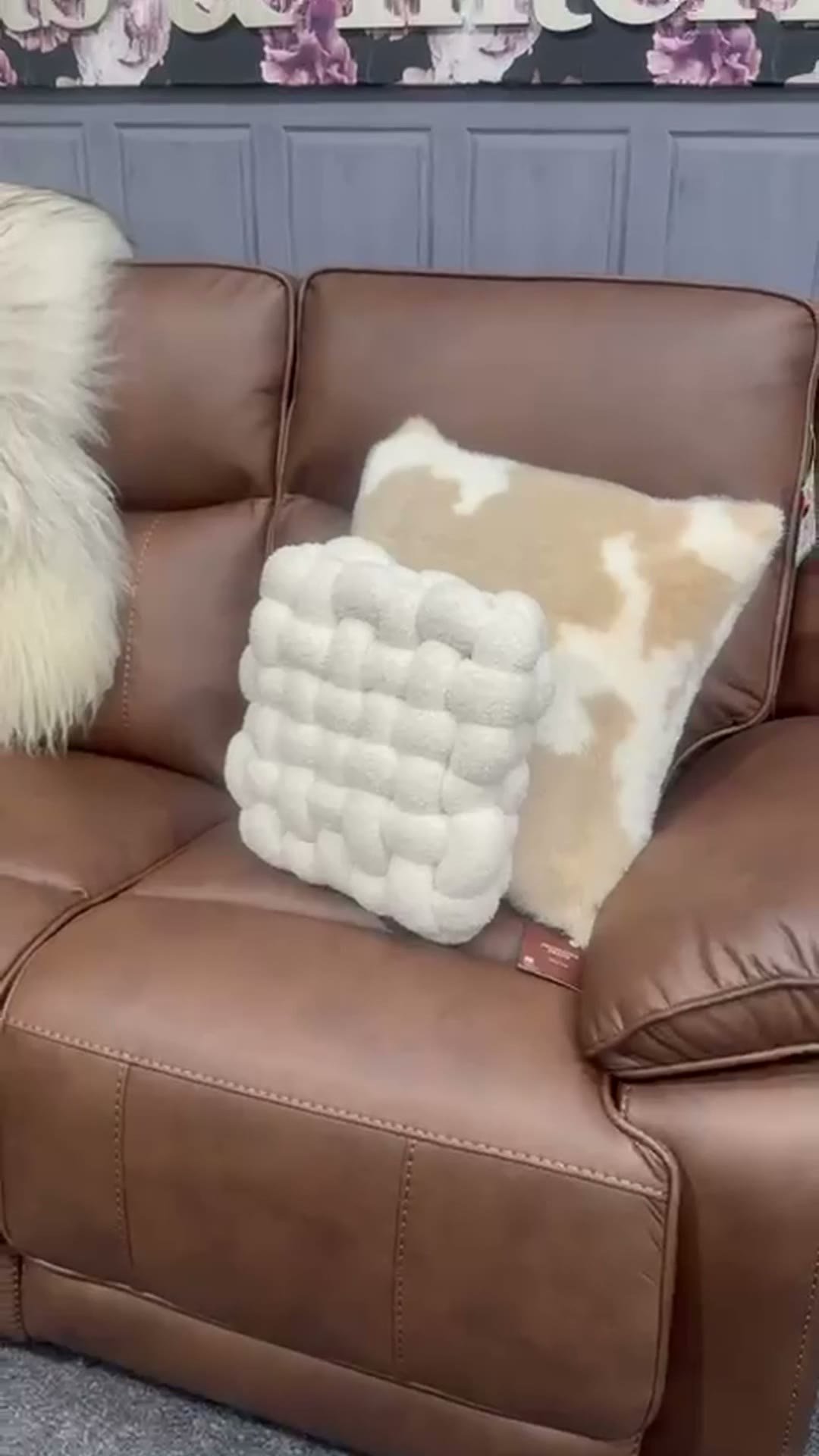 Tan leather recliner with cushions