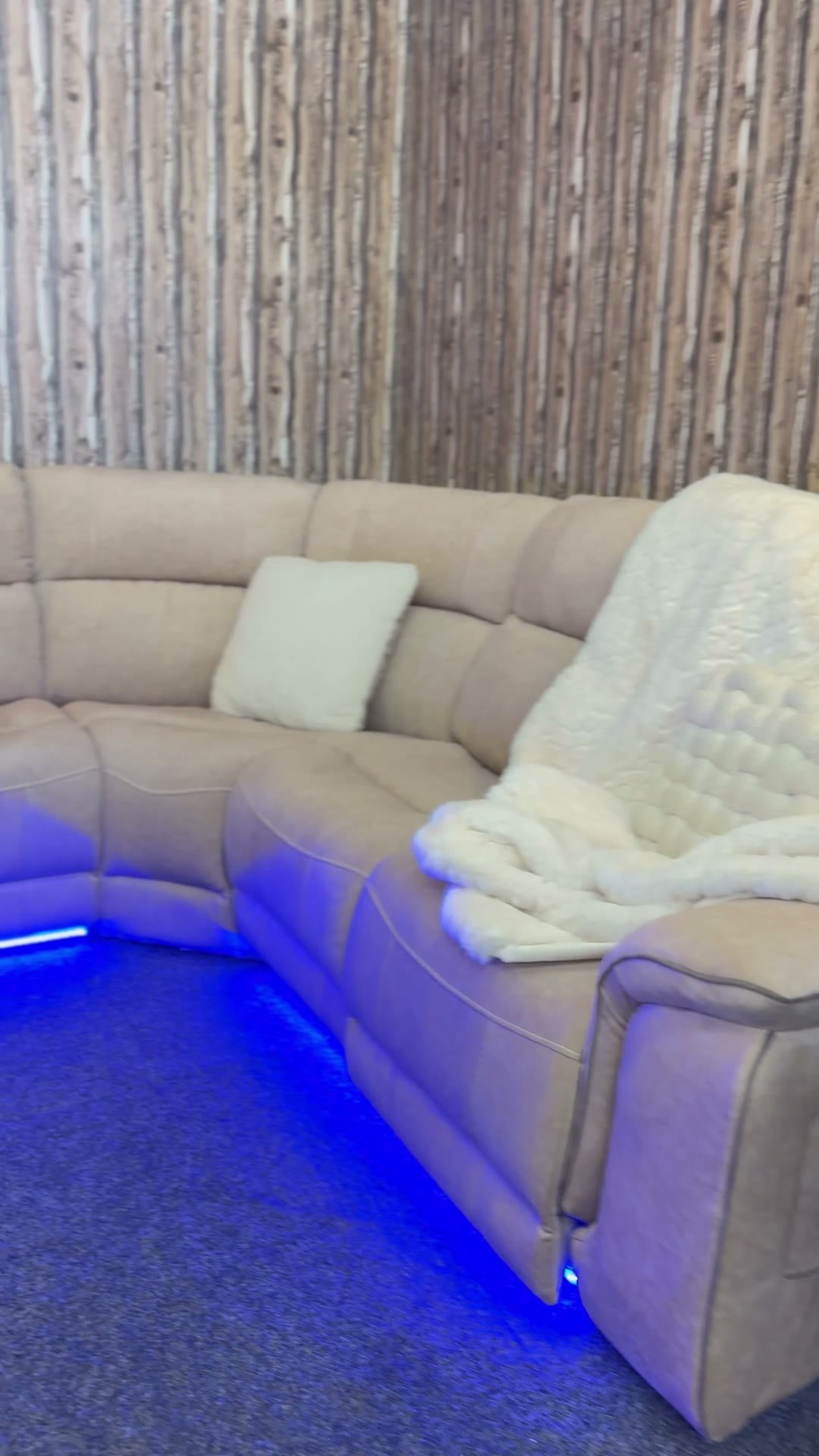 Cream sectional recliner with blue LED base lighting